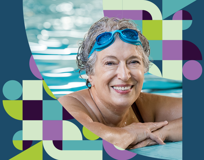 Old woman at the edge of the pool looking into the camera and smiling
