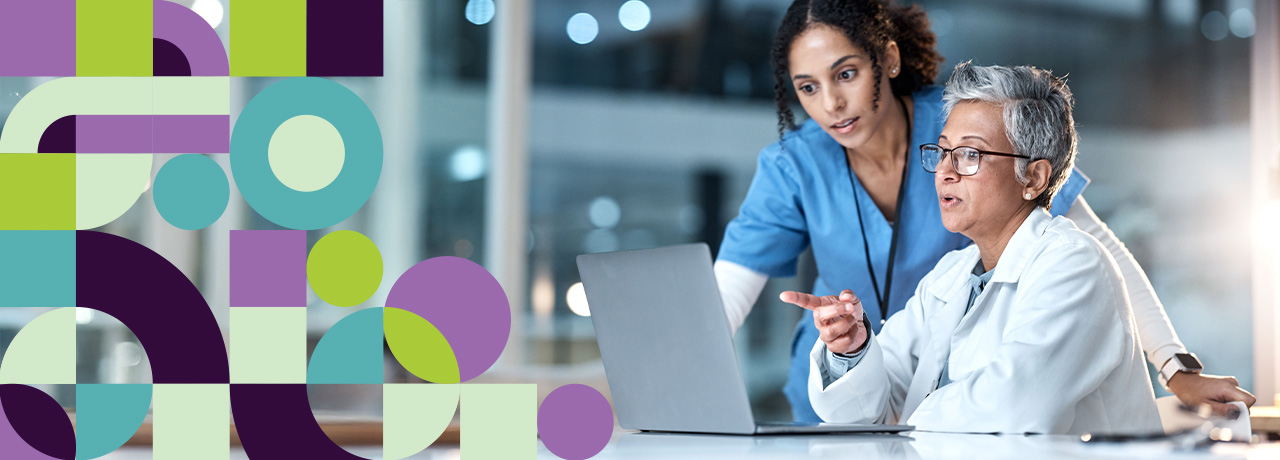 Doctors collaborating while looking at a laptop screen
