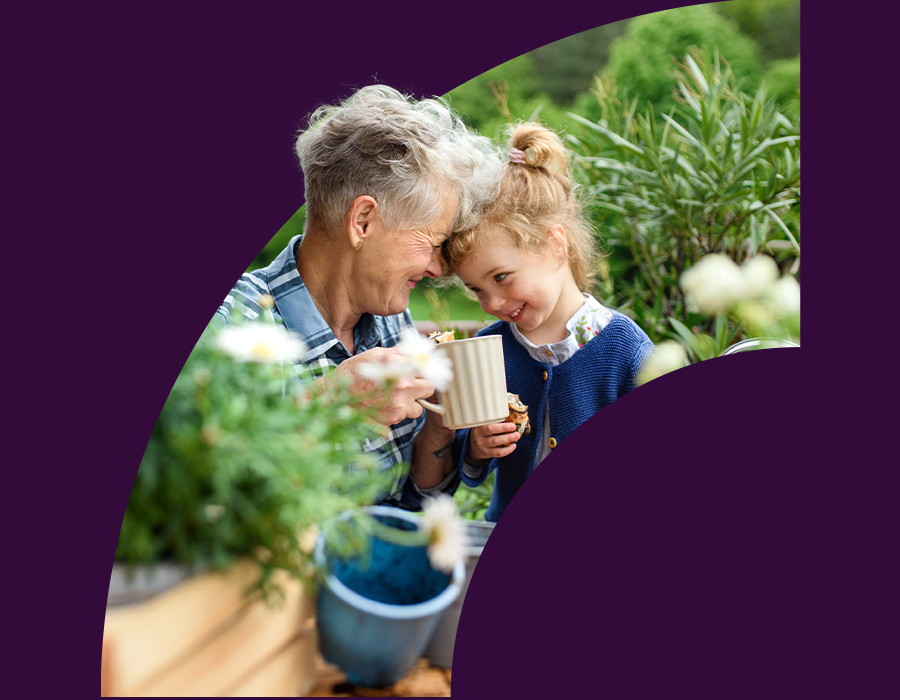 Grandmother and grand daughter connecting in a garden