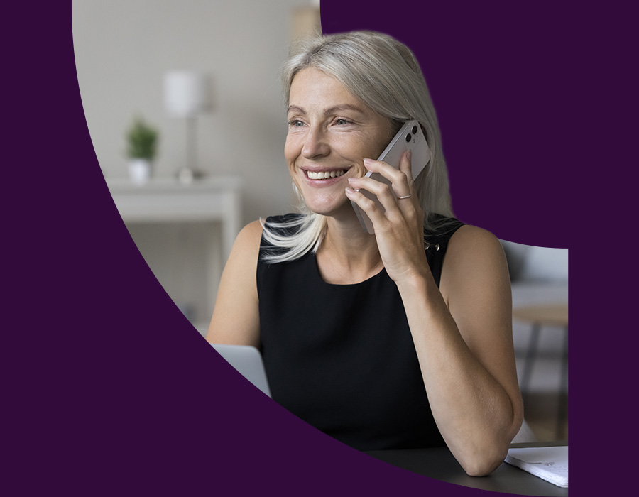 Middle-aged woman speaking on her phone and smiling