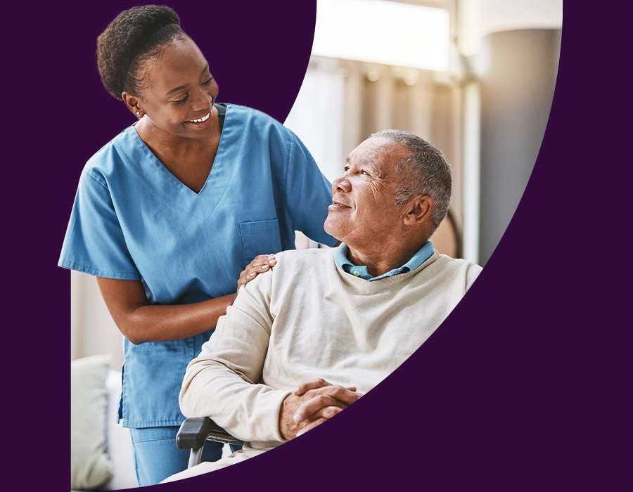 Black nurse tending to old black man at home