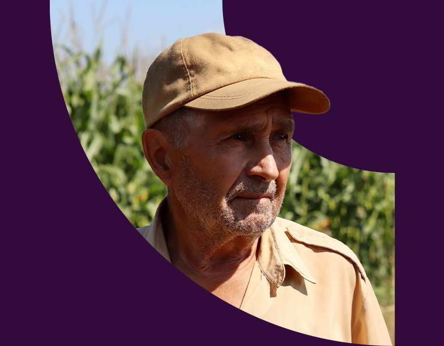 Farmer standing in front of a field of corn