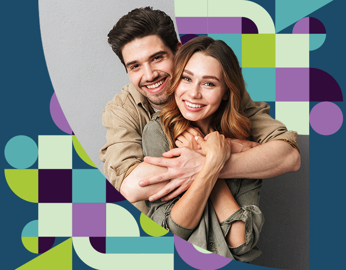 Young couple embracing and looking at the camera